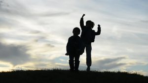 silhouette two boys